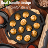 Black baking pan with handles containing baked goods on a wooden surface.