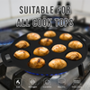 Black cast iron pan with baked goods on a stove, suitable for various cooktop types.