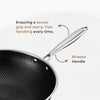 Black frying pan with riveted handle on a white background