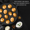 Cast iron cookware with baked goods and a small bowl of cream on a dark background