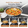 Multi-use wokpan with various dishes on a stove, including fried rice, tofu, and stir-fried vegetables.