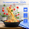 Pre-seasoned cast iron kadai with spaghetti and vegetables on a wooden surface, featuring text about its cooking properties.