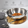 Stainless steel wok with food on a wooden trivet, with cleaning and durability icons.