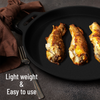 Three fried food items on a black pan with a fork, on a dark surface.