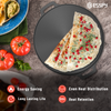 Two slices of flatbread with pomegranate seeds on a black stone surface, surrounded by tomatoes and guacamole.