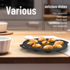 Black round pan with baked items on a wooden surface, kitchen setting.