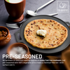 Pre-seasoned cast iron skillet with flatbread and ingredients on a dark surface