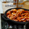 Black cast iron skillet with shrimp on a stove, suitable for all cooktops.
