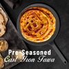 Pre-seasoned cast iron tawa with cooked parathas on a dark background