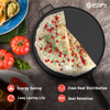 Round black frying pan with a tortilla topped with pomegranate seeds on a gray surface, surrounded by tomatoes and guacamole.