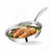 Stainless steel frying pan with salmon and vegetables on a white background