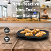 Baked goods in a black baking tray on a wooden surface with kitchen background