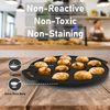 Black cast iron pan with baked goods on a wooden surface, kitchen blurred in the background