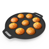 Black non-stick muffin pan with baked muffins on a white background