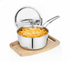 Stainless steel pot with macaroni and cheese on a wooden trivet against a white background