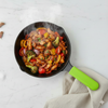 Frying pan with stir-fry on a marble surface